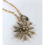 A 9ct gold six point star pendant set seed pearls on 9ct gold chain, 3.7gm gross