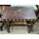 A rectangular oak foot stool with studded Portuguese leatherwork seat