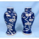 A near-matching pair of Chinese blue and white baluster vases. With prunus blossom decoration. 4