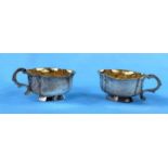 An 18th century pair of Russian silver oval single handled white metal drinking vassals bearing