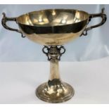 A hallmarked silver trophy bowl, 2 handles and pedestal base with ornate relief decoration,