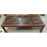 A 1960's rectangular coffee table with walnut framed ceramic top in the style of Poole