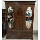 An Edwardian inlaid mahogany double wardrobe in the Sheraton style, with part fitted interior,