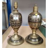 An Islamic pair of brass vases of oval pedestal form, with pierced decoration and silvered metal