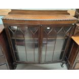 A mahogany bookcase top enclosed by 2 glazed doors