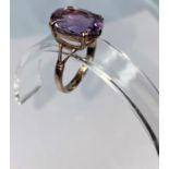 A 9 carat gold dress ring set large amethyst coloured stone, 4.8 gm. size R.5