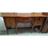 A Georgian style mahogany sideboard with serpentine front, central drawer and side cupboards (