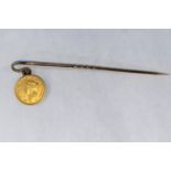 A miniature USA 1853 gold one dollar coin on a yellow metal pin (tests approx 9ct) gross 2.7gm