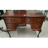 A mahogany period style kneehole desk with 4 drawers, on cabriole legs