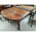 An early 19th century mahogany dining table with 'D' end extending top, on turned and fluted legs