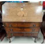 A 1930's walnut fall front bureau with 3 drawers below