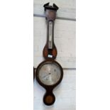 An Edwardian aneroid barometer with thermometer, in Sheraton style inlaid mahogany banjo shaped