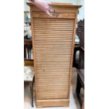 A 1930's office pedestal filing cabinet with tambour front and internal sliding trays