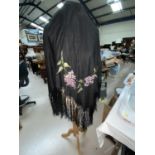 Two embroidered fringed black shawls in the Madeira style; 3 other shawls (some damage / holes0