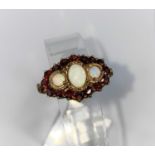 A vintage 9ct hallmarked dress ring set with 3 opals surrounded by 16 garnets size Q 5.7gms