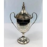 A hallmarked silver covered trophy cup with 2 handles, inscribed, London 1932, 5 oz