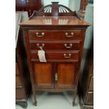 An Edwardian Sheraton style music cabinet with 3 drawers and double cupboard