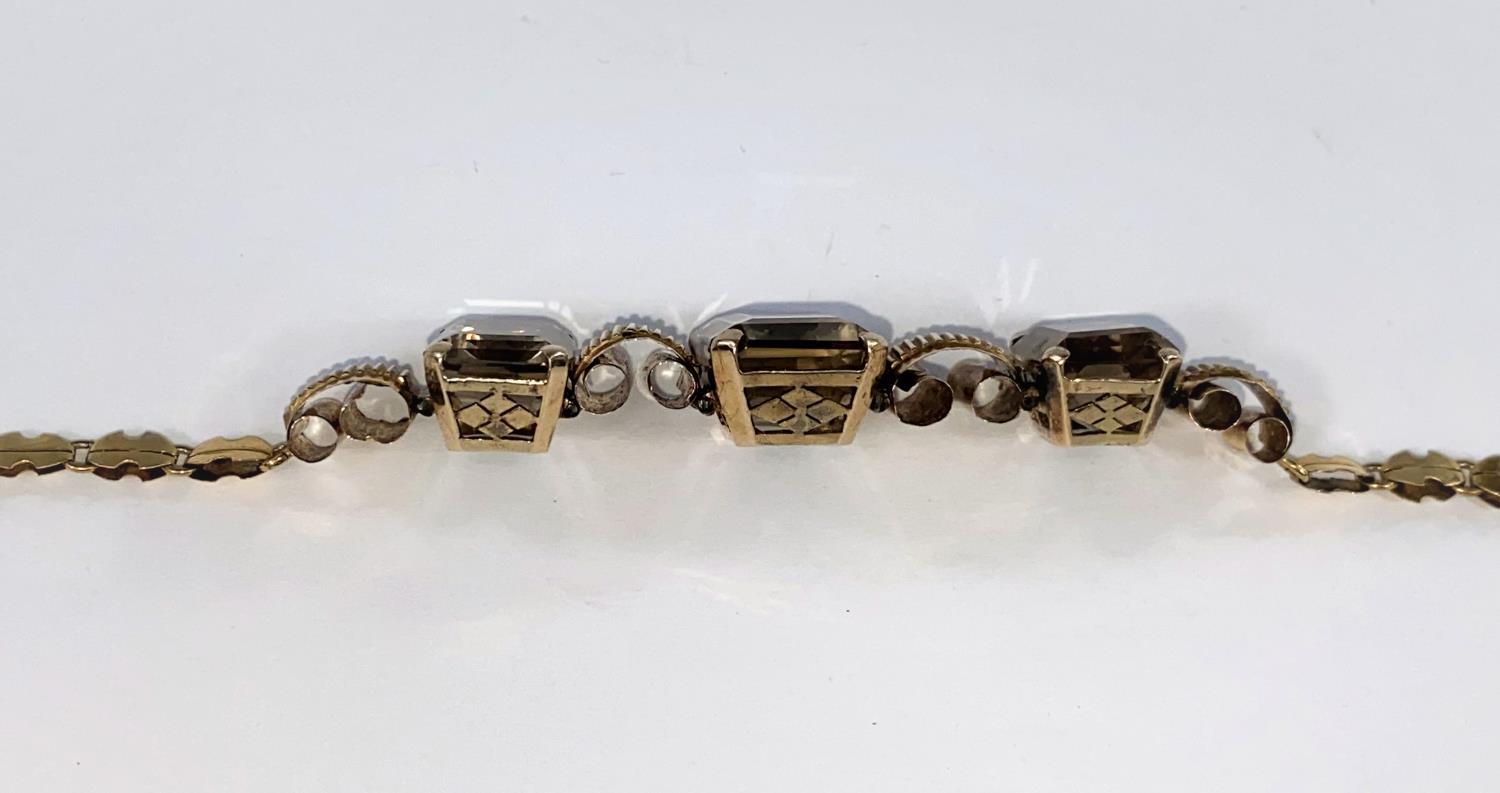 A continental yellow metal bracelet set with 3 rectangular Smokey citrine stones tested 14ct, - Image 3 of 4