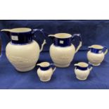 A graduating set of 5 19th century Parian ware jugs decorated with hunting scenes in relief (