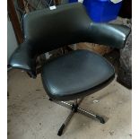 A modernist designer (possibly Danish) leather effect and chrome swivel arm chair in black.