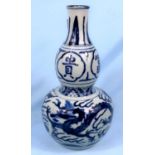 A Chinese blue and white double gourd vase with dragon decoration height 31cm