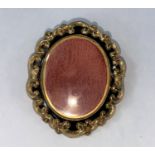 A Victorian double sided mourning brooch with black enamel and rococo gilt surround, height 5.5cm