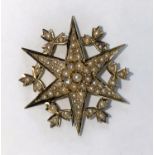 A 15 carat gold six point star brooch set see pearls, 7.4gm gross