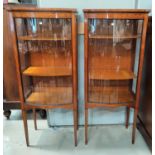 A pair of Edwardian satinwood d-fronted glass display cabinets with ebonised inlay, double side