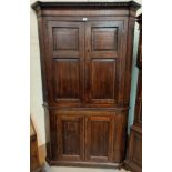 A Georgian oak full height corner cupboard with dentil cornice, inlaid frieze, reeded side