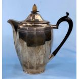 A hallmarked silver coffee pot of ribbed oval form with pineapple finial and chased decoration