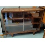 A 1960's walnut side cabinet enclosing sliding glass doors; a similar tea trolley (top corner split)