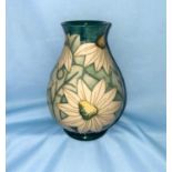 A Moorcroft baluster vase decorated with white star shaped flowers, impressed and monogrammed,