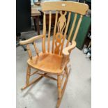 A modern light wood fiddleback rocking chair, three modern country style kitchen chairs