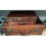 A vintage leather travel suitcase in tan colour, monogrammed H.L.B. and a similar smaller one.