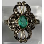 An early 20th century emerald & diamond ring comprising of a central oval emerald with 33 diamonds