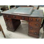 A Victorian mahogany Dickensian style desk with raised slope front writing surface, the kneehole