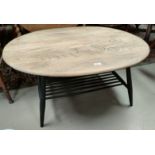 An Ercol coffee table with lightwood oval top, painted legs and undershelf