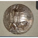 A WWI bronze memorial plaque, name erased