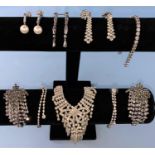 A white metal and clear stone bracelet stamped 925; a diamante necklace and 5 pairs of similar