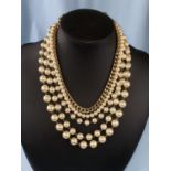 An Italian Sodini simulated pearl and gilt necklace wih 4 graduating strands of pearls and a gilt