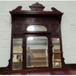 An Edwardian overmantel mirror in carved mahogany frame
