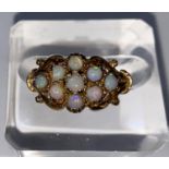 A 9 carat hallmarked gold dress ring set 9 opal coloured stones, 3 gm, size K (1 stone slight chip)