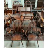An Ercol dark oak dining suite comprising drop leaf table and 6 (4 + 2) chairs
