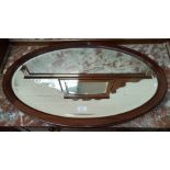Two oval wall mirrors in mahogany frames