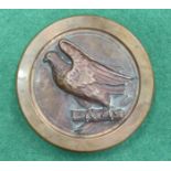 A Naval bronze ship's plaque cast in high relief with an eagle on branches, 16cm diameter