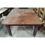 A Victorian mahogany dining table with rounded rectangular wind out top and 2 spare leaves, on