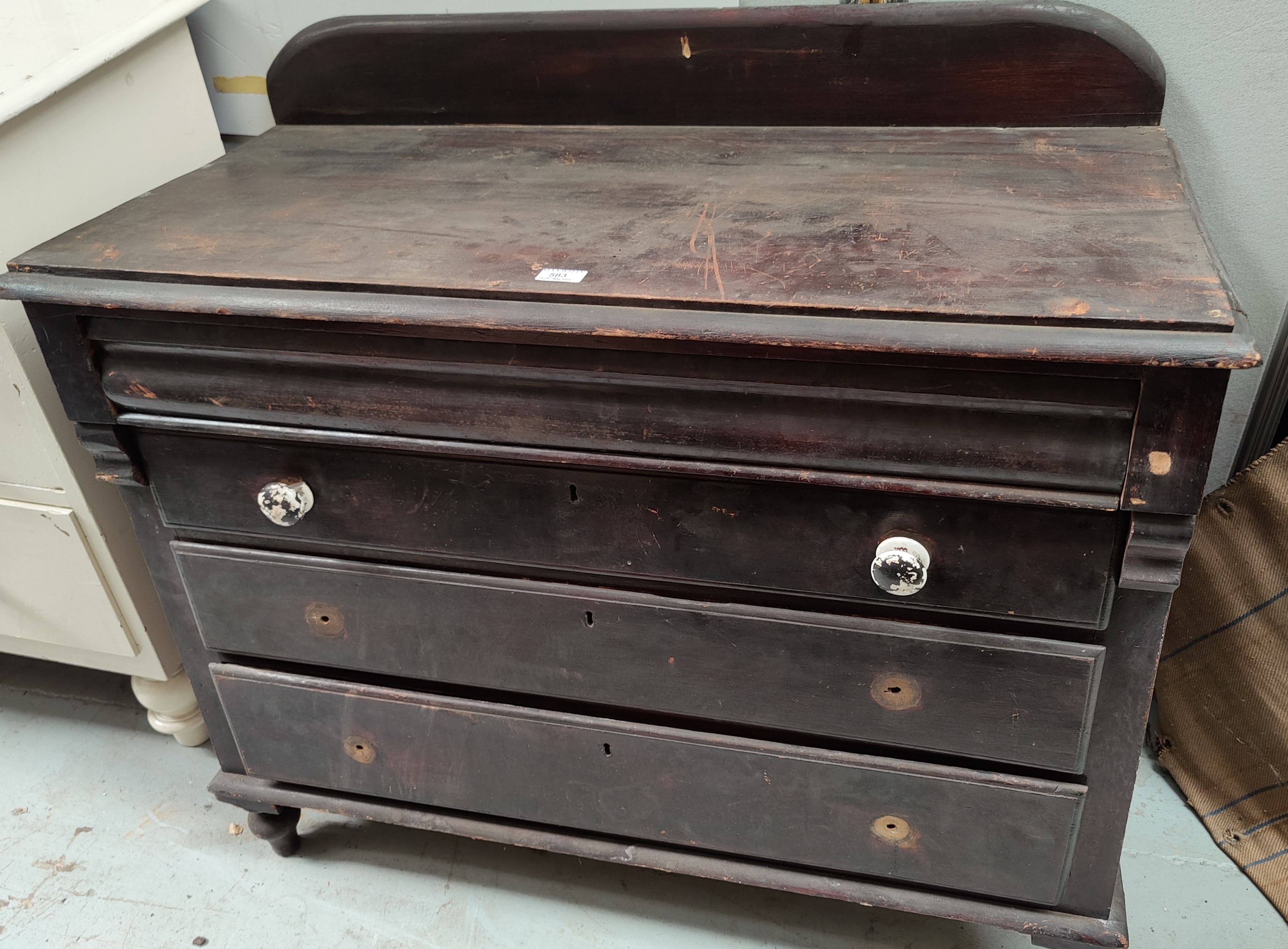 A Victorian stained pine chest of 3 long drawers