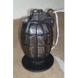 A deactivated hand grenade paperweight