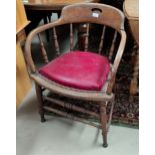 A smoker's/captain's oak armchair with bow stick back and red leather effect cushion