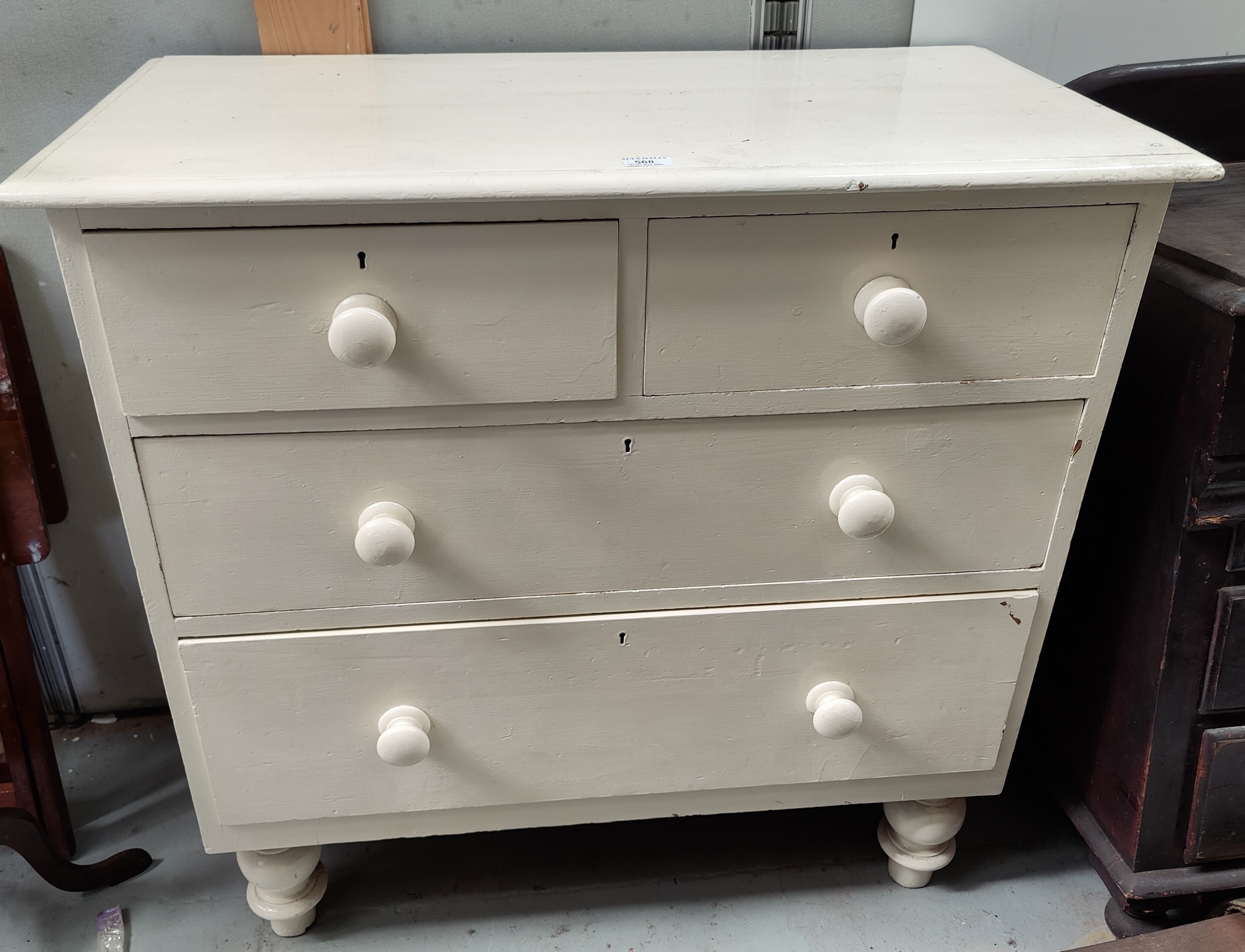 A 19th century white painted pine chest of 2 long and 2 short drawers